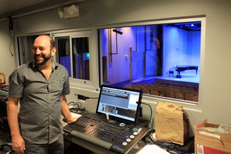 Auditorium manager David Ortolano at the lighting controls of the Stewart Auditorium. Photo by Peter Alexander.